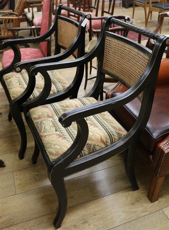 A pair of Regency style ebonised ropetwist back elbow chairs